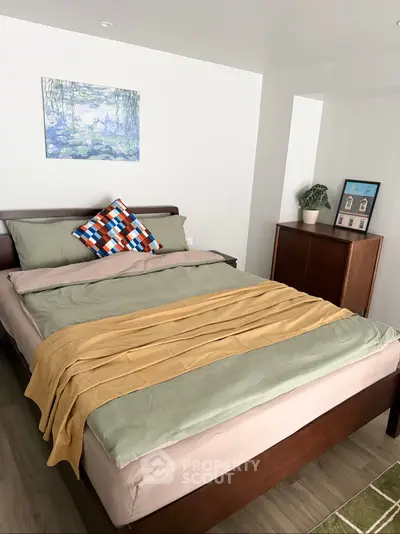 Cozy bedroom with modern decor and stylish bedding in a well-lit space.