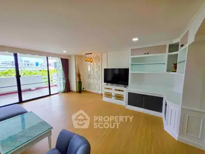 Spacious living room with modern decor and large balcony access