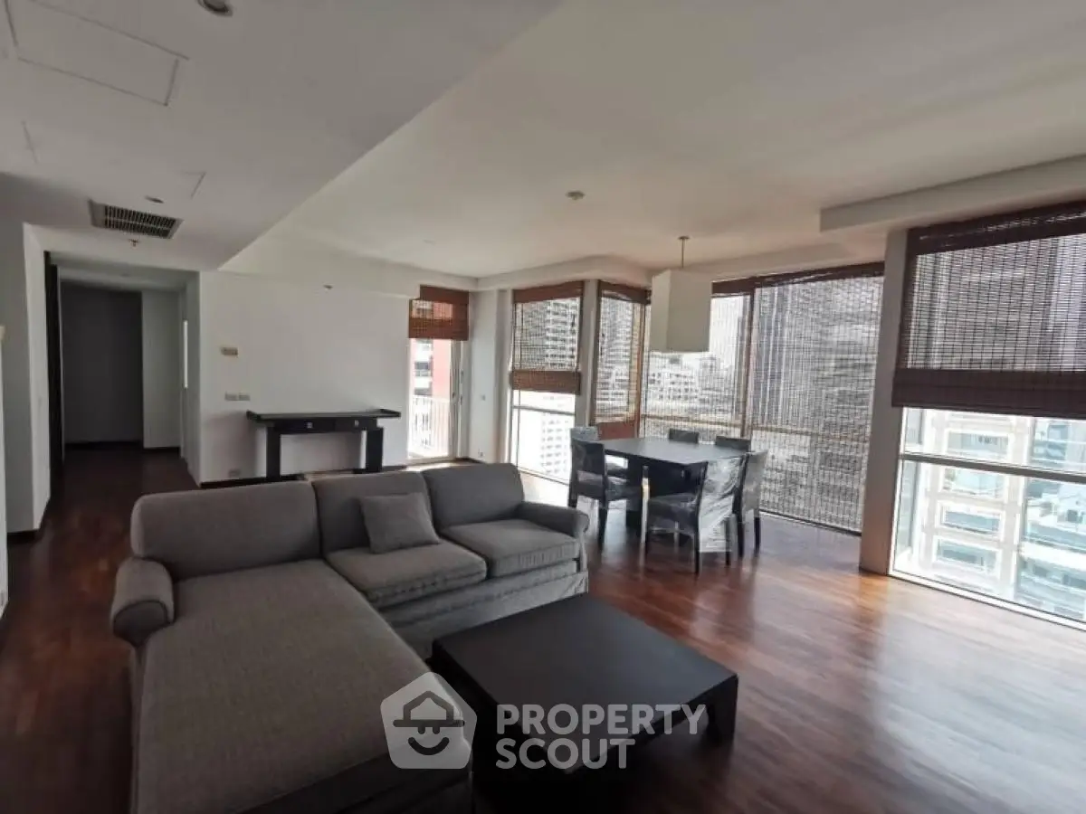 Spacious modern living room with large windows and wooden flooring