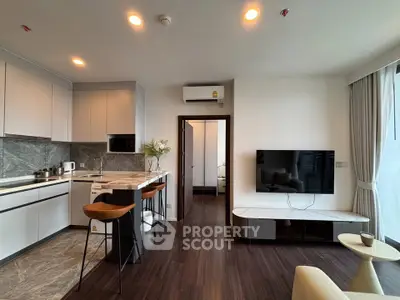 Modern open-plan living room with sleek kitchen and stylish decor