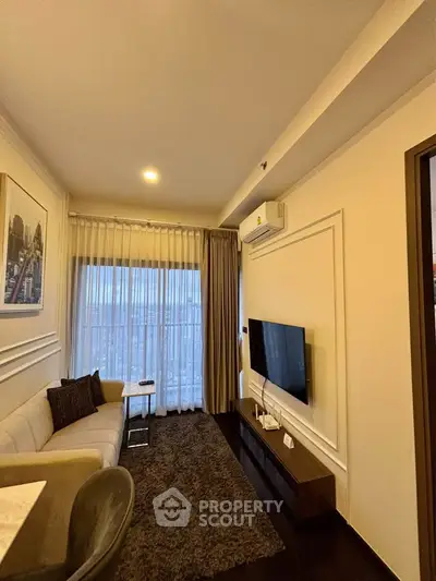Modern living room with stylish decor, cozy seating, and large window for natural light.