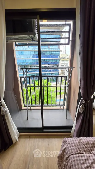 Charming small balcony with city view, perfect for urban living in a modern apartment.