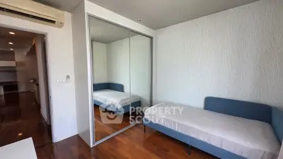 Modern bedroom with mirrored closet and sleek design