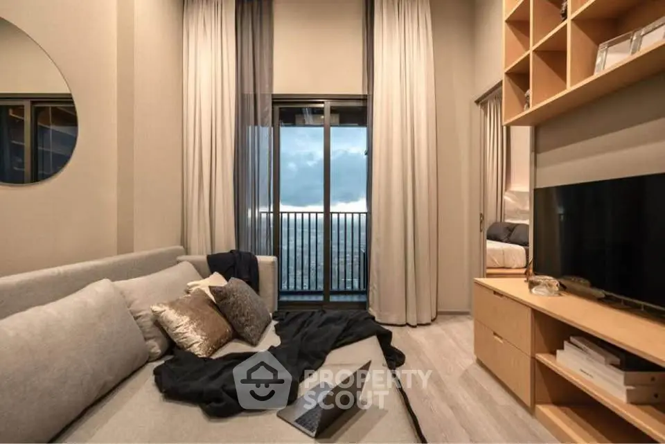 Modern living room with city view, cozy sofa, and stylish decor