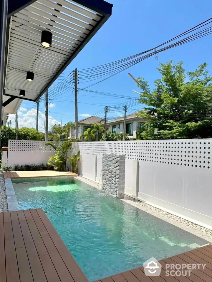 Luxurious private pool with modern deck and serene surroundings in upscale neighborhood.