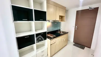 Modern compact kitchen with sleek cabinetry and built-in appliances in a stylish apartment.