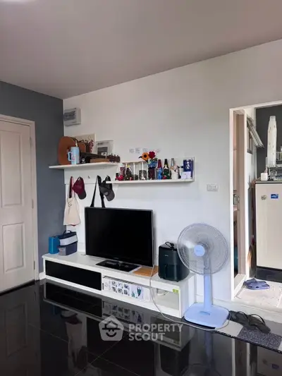 Modern living room with sleek TV setup and stylish shelving