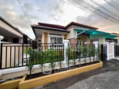 Charming single-story house with modern facade and lush garden