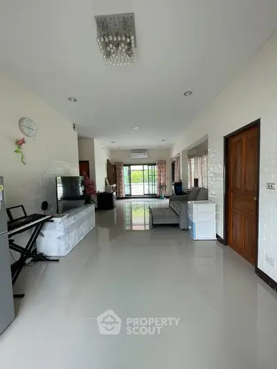 Spacious living room with modern decor and large windows offering natural light