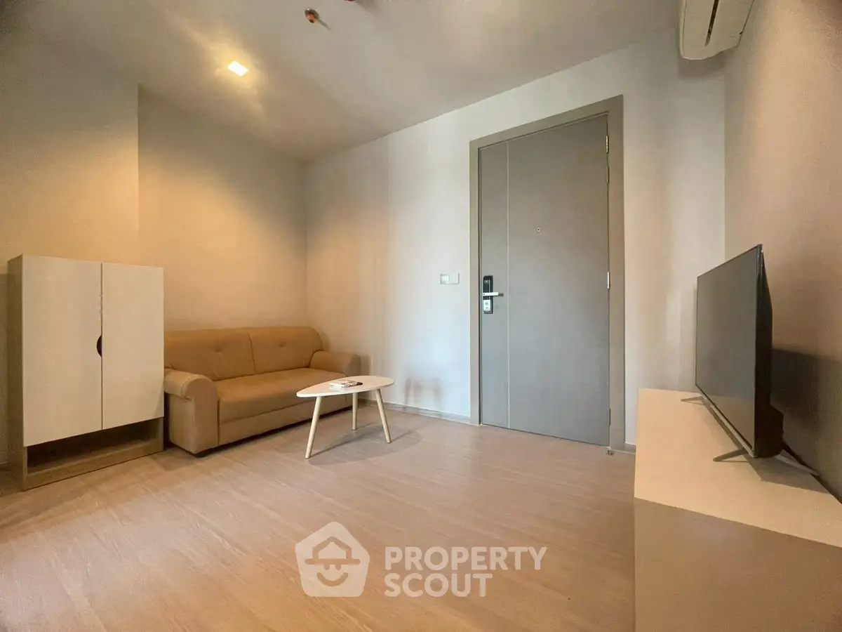 Modern minimalist living room with beige sofa and flat-screen TV