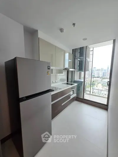 Modern kitchen with sleek cabinets and city view from large window