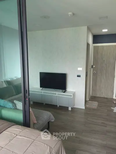 Modern apartment interior with cozy living area and sleek TV setup