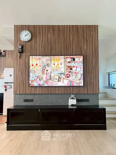 Modern living room with stylish wood paneling and large wall-mounted TV, featuring sleek storage solutions.