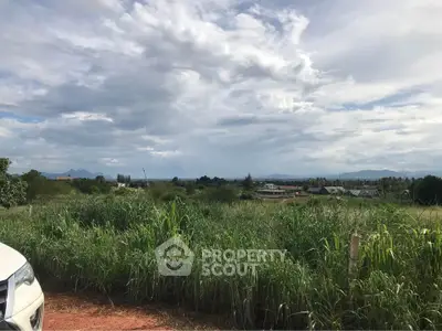 Scenic land plot with lush greenery and distant mountain views, perfect for development or investment.