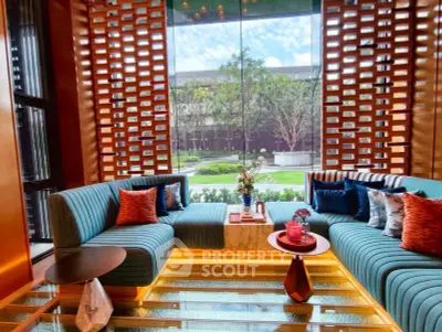 Luxurious living room with modern design and garden view, featuring stylish furniture and vibrant decor.