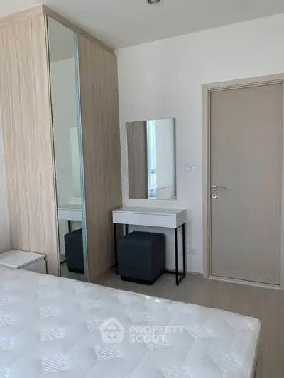 Modern bedroom with sleek wardrobe and stylish vanity area