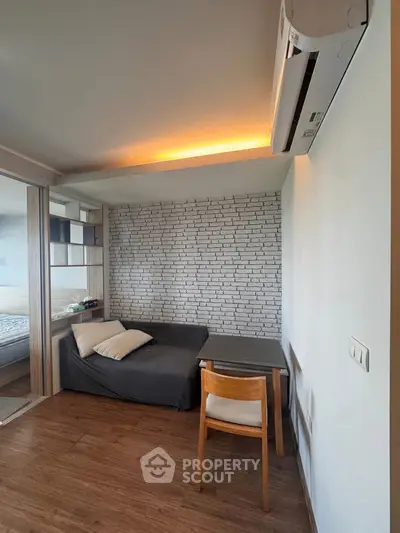 Cozy modern living space with stylish brick accent wall and wooden flooring