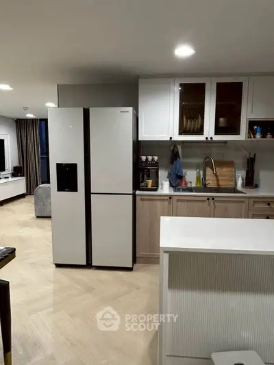 Modern kitchen with sleek appliances and open layout in a stylish apartment.