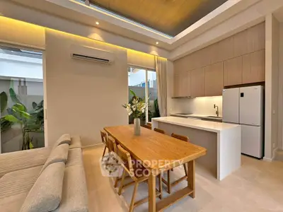 Modern open-plan kitchen and dining area with sleek design and natural lighting.