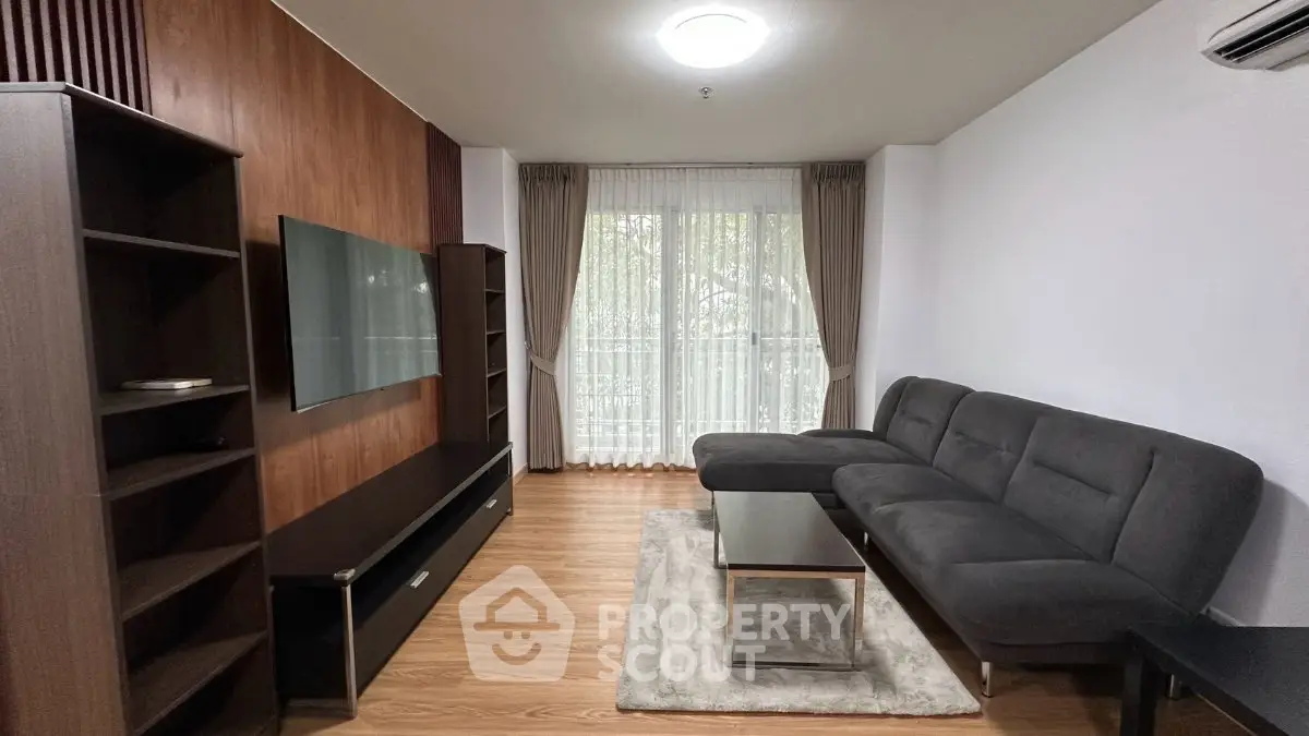 Modern living room with sleek furniture and large window for natural light.