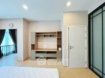 Spacious modern bedroom with built-in storage and natural light