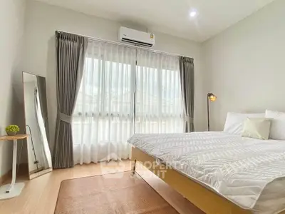 Bright and cozy bedroom with modern decor and large window