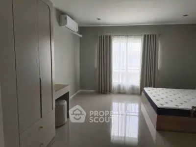 Spacious bedroom with modern furniture and natural light