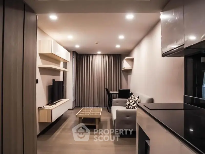 Modern living room with sleek furniture and ambient lighting in a stylish apartment.