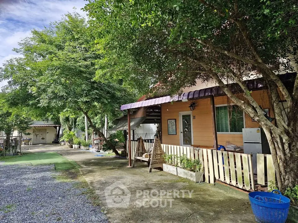 Charming countryside home with lush greenery and spacious outdoor area, perfect for serene living.