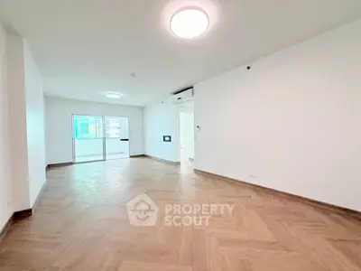 Spacious modern living room with wooden flooring and bright natural light