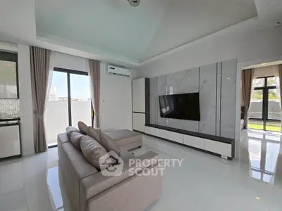 Spacious modern living room with sleek design and large windows offering abundant natural light.