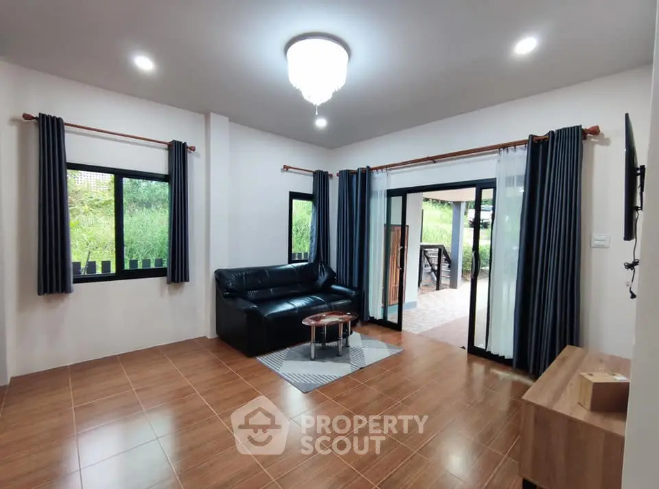 Spacious living room with modern decor and large windows for natural light