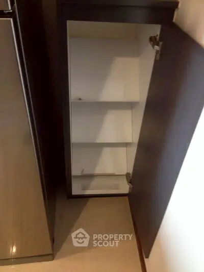 Modern kitchen storage cabinet with sleek design and ample shelving space.