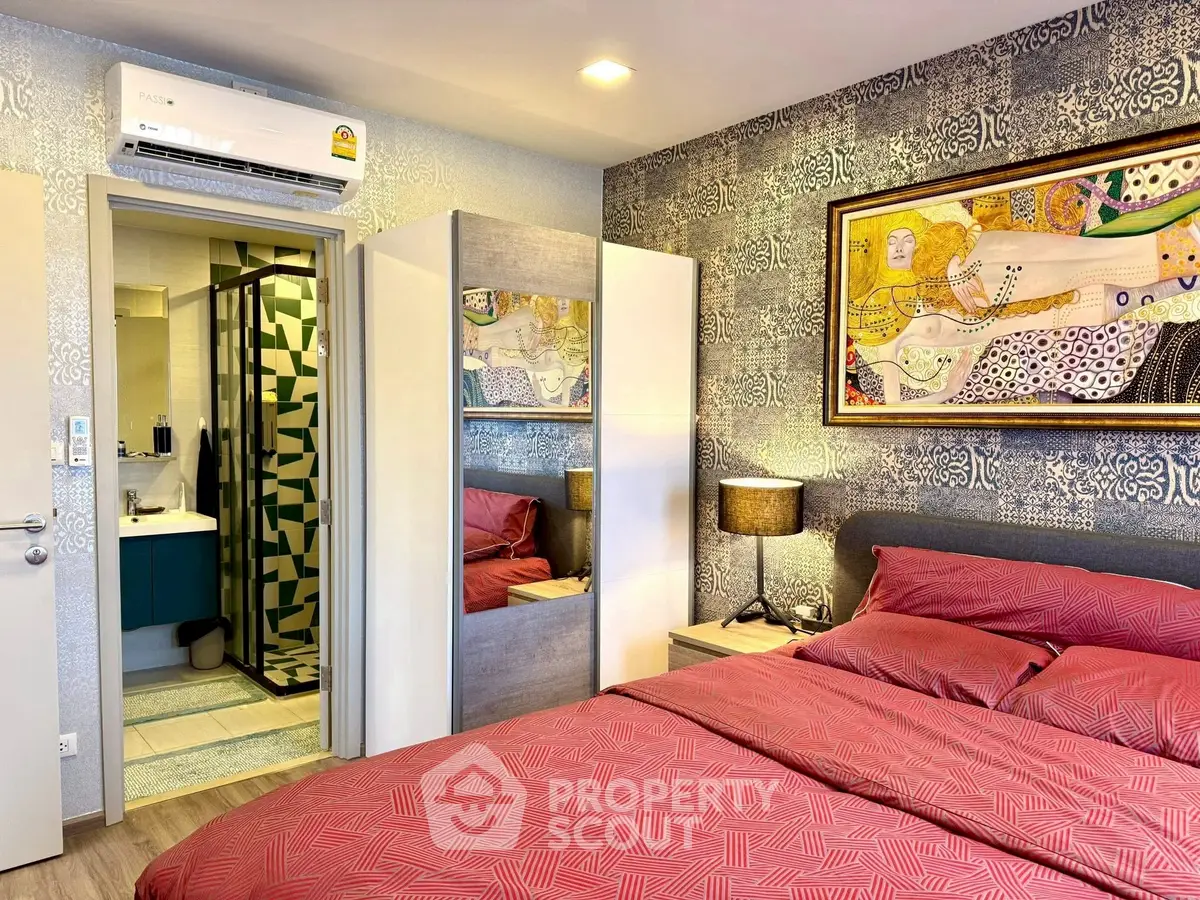 Stylish bedroom with modern decor and ensuite bathroom in a cozy apartment.