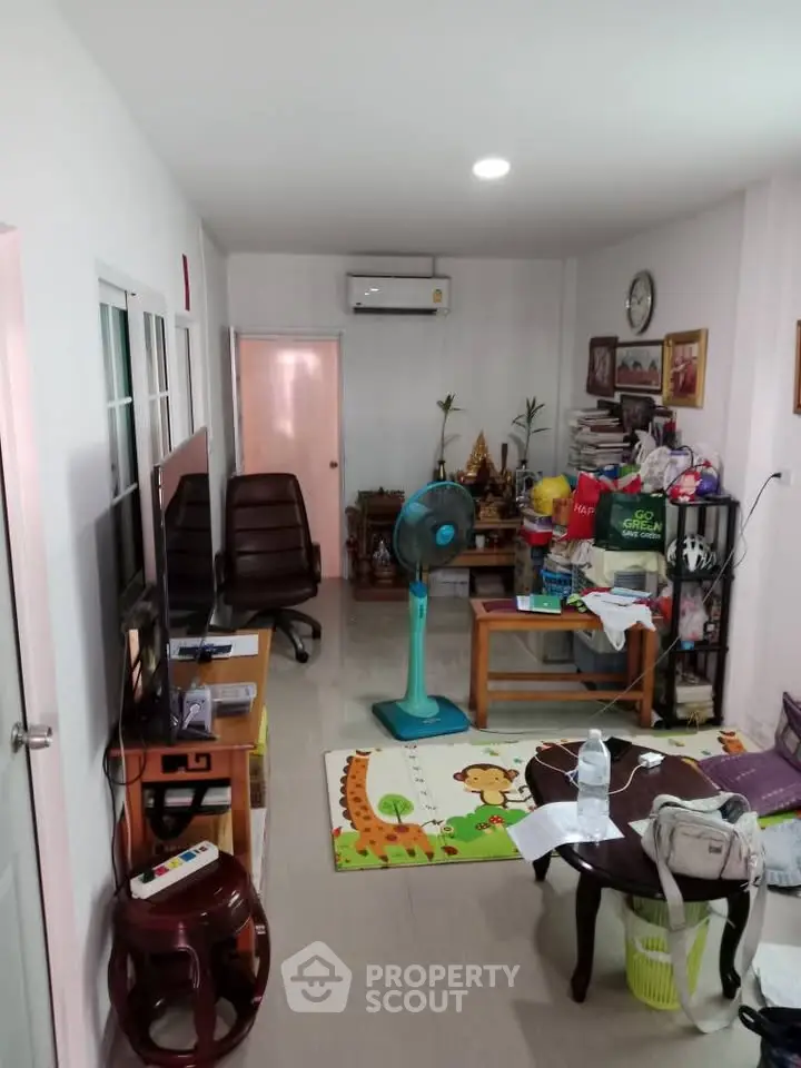 Cozy living room with eclectic decor and air conditioning, perfect for relaxation and entertainment.