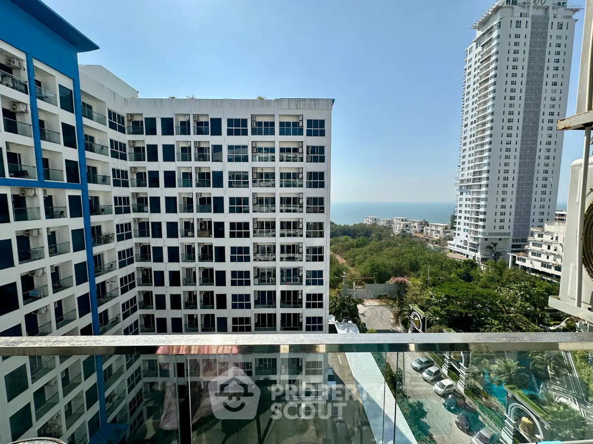 Stunning high-rise apartment view with ocean backdrop and modern architecture.