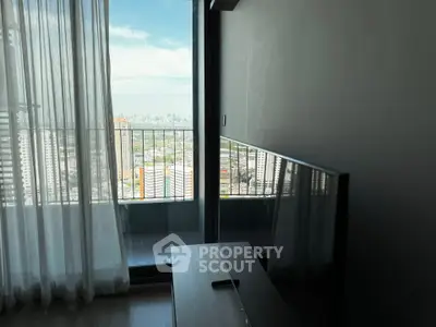 Modern apartment with stunning city view from the living room balcony, featuring sleek interior design.
