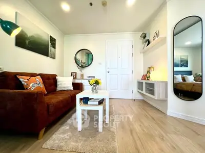 Charming living room with modern decor and cozy seating, perfect for relaxation and entertaining guests.