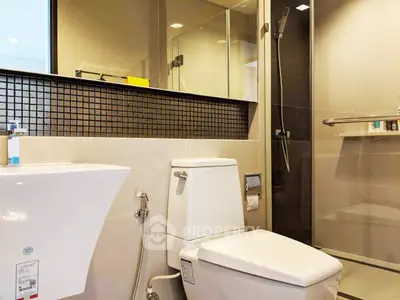 Modern bathroom with sleek fixtures and glass shower enclosure