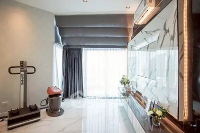 Luxurious modern living room with marble accents and fitness equipment