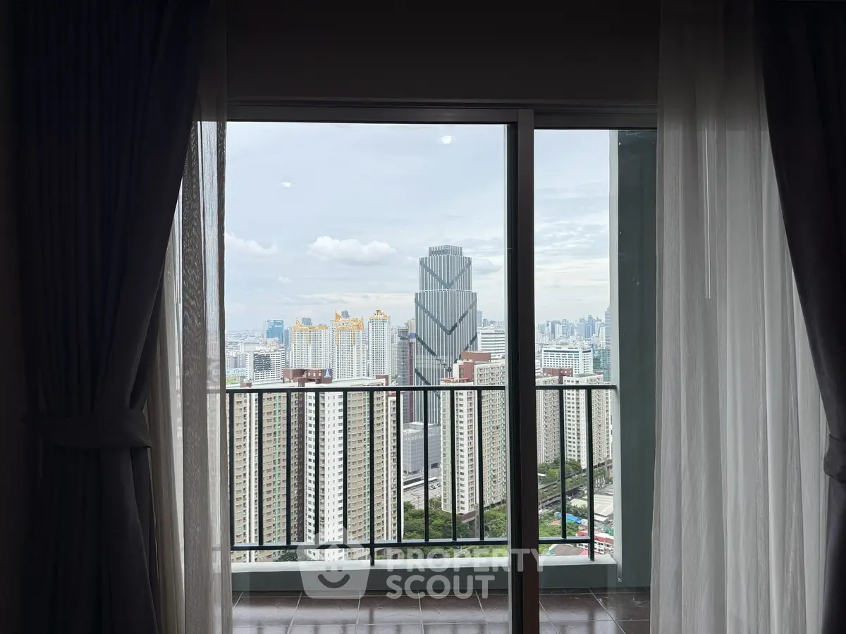 Stunning cityscape view from a high-rise apartment balcony with modern skyline.