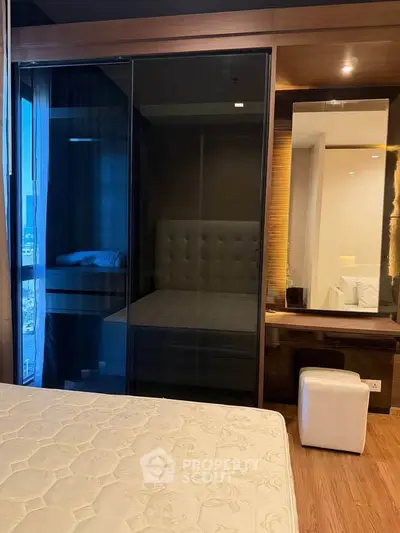 Modern bedroom with glass wardrobe and wooden accents