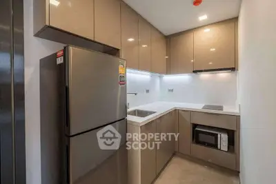 Modern kitchen with sleek cabinetry and stainless steel appliances in a compact layout.