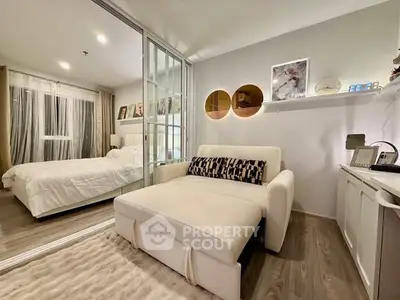 Stylish modern bedroom with cozy seating and elegant decor