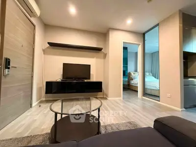 Modern living room with sleek furniture and open view into a cozy bedroom