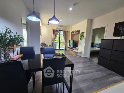 Modern living room with dining area, stylish decor, and balcony view in a contemporary apartment.