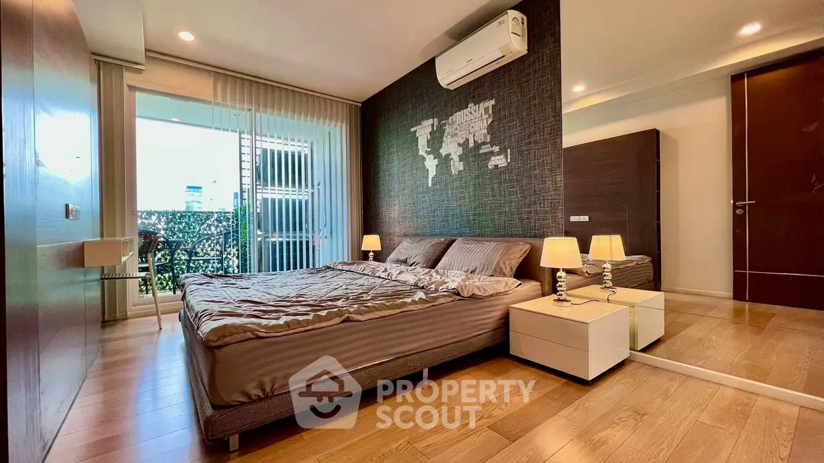 Luxurious bedroom with modern decor and balcony access in a high-end apartment.
