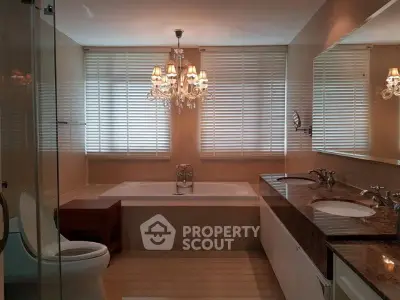 Luxurious bathroom with elegant chandelier and dual sinks