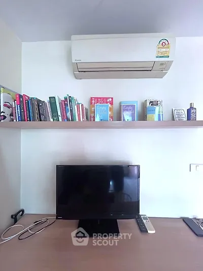 Modern study nook with air conditioning and bookshelf, perfect for productivity.