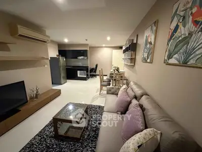 Spacious modern living room with elegant decor and cozy seating area, perfect for relaxation and entertainment.